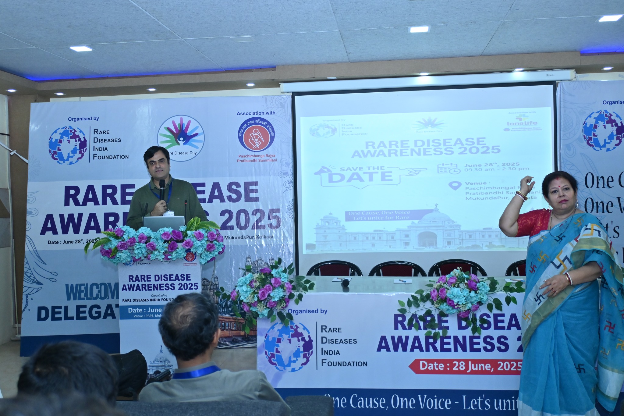 A doctor explaining a medical diagram to attendees.